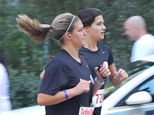 Two staff running in event