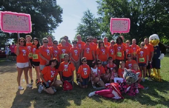 Community event at park with matching shirts and signs